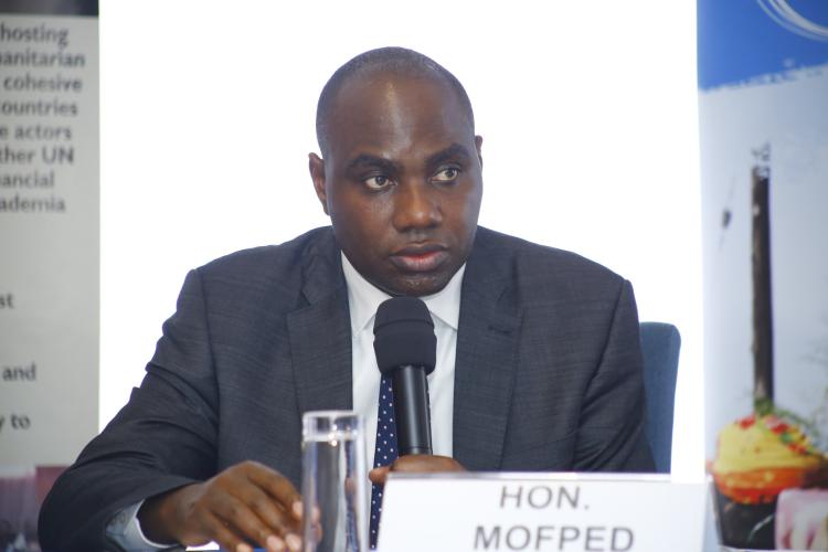 Minister of State for General Duties Hon. Henry Musasizi at the opening of the Transition Management in Uganda's Refugee Response Roundtable at Golden Tulip Hotel in preparation for the Global Refugee Forum in December 2023