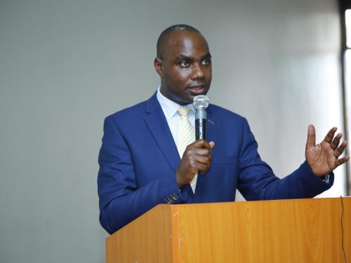 State Minister for Finance Hon. Musasizi Henry making his remarks at the Local Government Internal Auditors Association Annual General Meeting